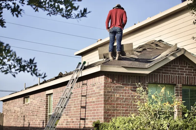 Professional roofer working on a residential roof in Herndon Junction